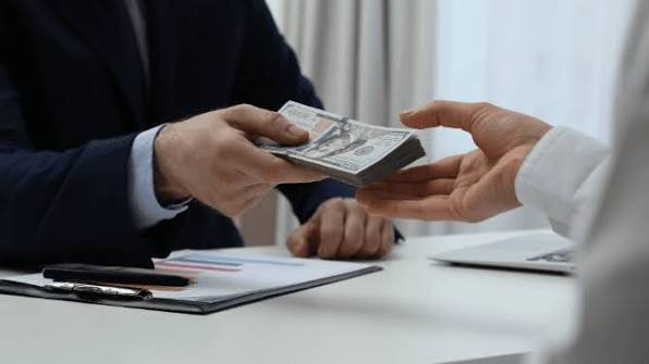 paying with money photo of How Long Does It Take to Buy an Apartment in Kenya